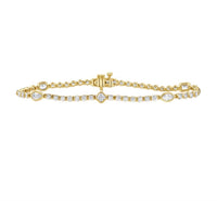 The Karat Concierge Kate bezel set tennis bracelet in yellow gold with mixed shape diamonds and a secure clasp.