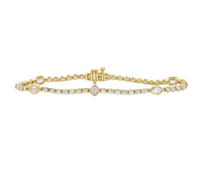 The Karat Concierge Kate bezel set tennis bracelet in yellow gold with mixed shape diamonds and a secure clasp.