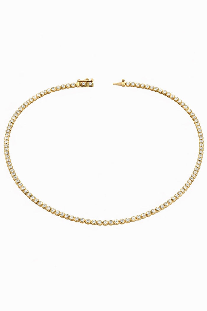 The Karat Concierge 14K yellow gold tennis necklace with bezel set stones in a classic 16-inch length.