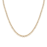 The Karat Concierge 14K yellow gold tennis necklace featuring a continuous line of bezel set round brilliant diamonds.