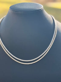 The Karat Concierge bezel set tennis necklace featuring 3.5 carats of sparkling stones on a black display bust.