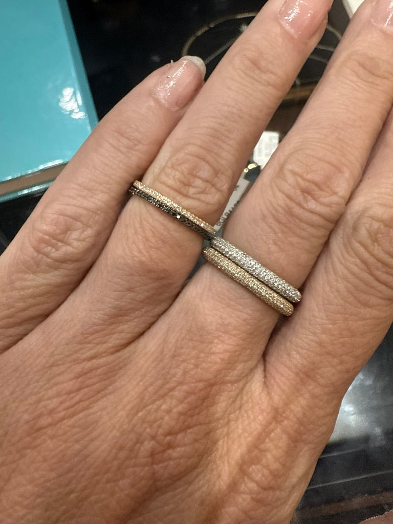 The Karat Concierge black diamond eternity band in 14K yellow gold with black rhodium worn on a finger