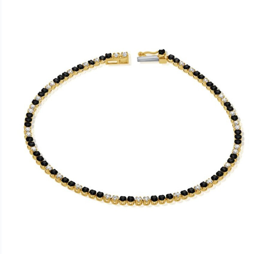The Karat Concierge black diamond and white diamond tennis bracelet in 14K yellow gold with a secure clasp