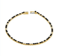 The Karat Concierge black diamond and white diamond tennis bracelet in 14K yellow gold with a secure clasp