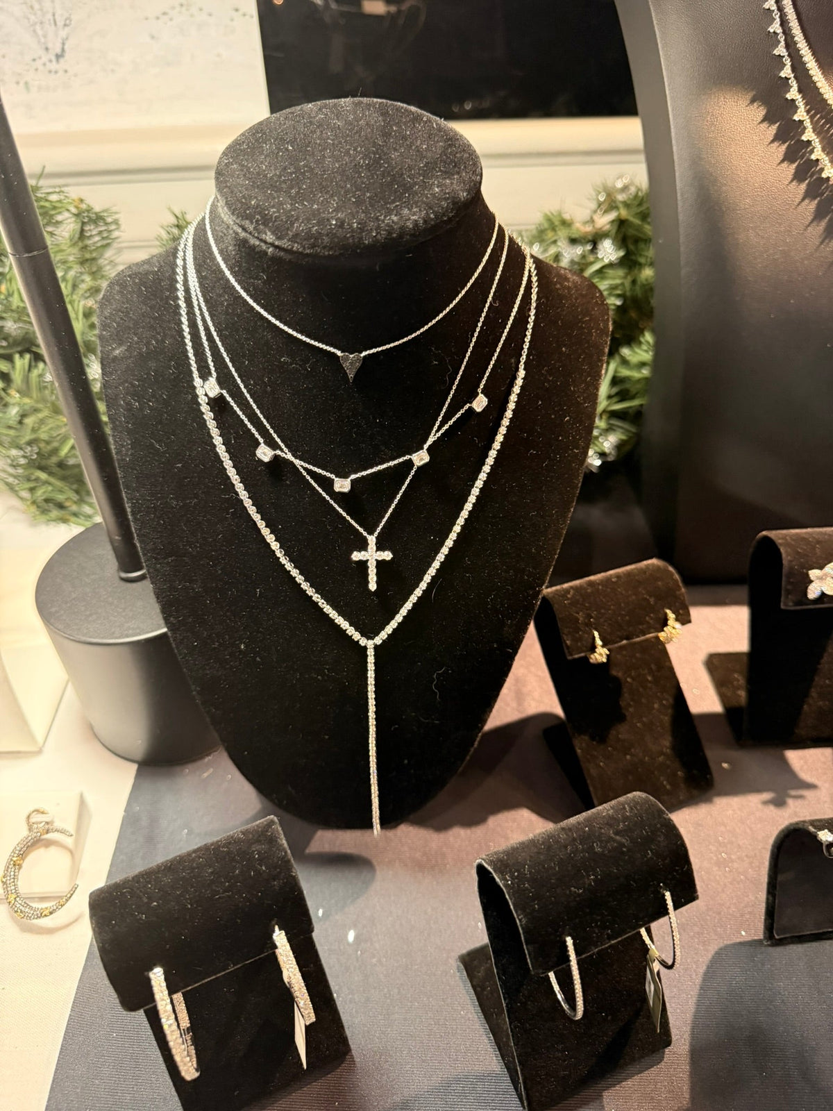 The Karat Concierge layered necklace set featuring a micro elongated heart pendant with black diamonds on a silver chain