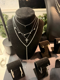 The Karat Concierge layered necklace set featuring a micro elongated heart pendant with black diamonds on a silver chain