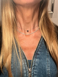 The Karat Concierge micro elongated heart pendant necklace featuring black diamonds set in black rhodium and white gold