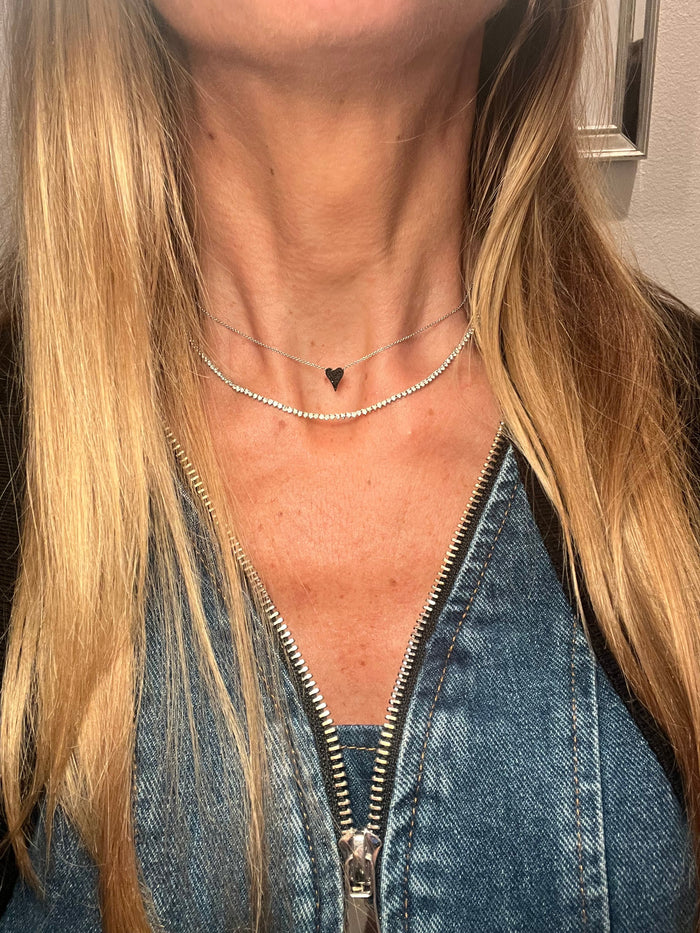 The Karat Concierge micro elongated heart pendant necklace featuring black diamonds set in black rhodium and white gold