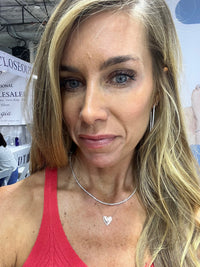 The Karat Concierge Amore bubble heart necklace in 14K white gold with diamond accents worn by a blonde woman.