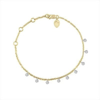 The Karat Concierge 14k yellow gold dangle bracelet with nine brilliant diamonds in white gold bezels.