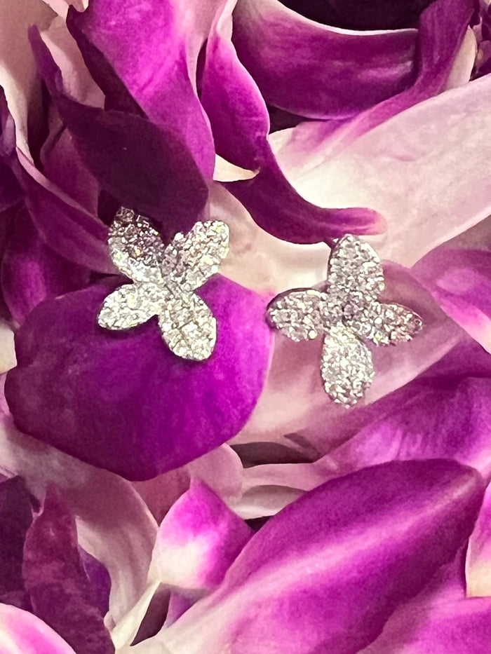 The Karat Concierge Lei Pave Flower Stud Earrings in 14K white gold with 1 CTW diamonds on purple orchid petals.