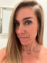 The Karat Concierge 14K white gold tennis necklace with 2 CTW diamonds worn by a woman with blonde hair