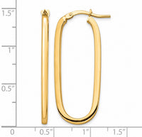 The Karat Concierge 14K yellow gold elongated paperclip hoop earrings with a polished finish on a measurement grid.