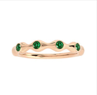 The Karat Concierge 18K gold bamboo ring featuring four round emerald gemstones in a delicate, stackable design.