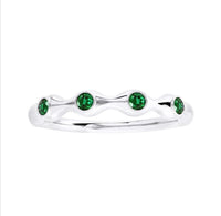 The Karat Concierge bamboo-style ring in 18K gold featuring four round green emerald gemstones in a stackable design.