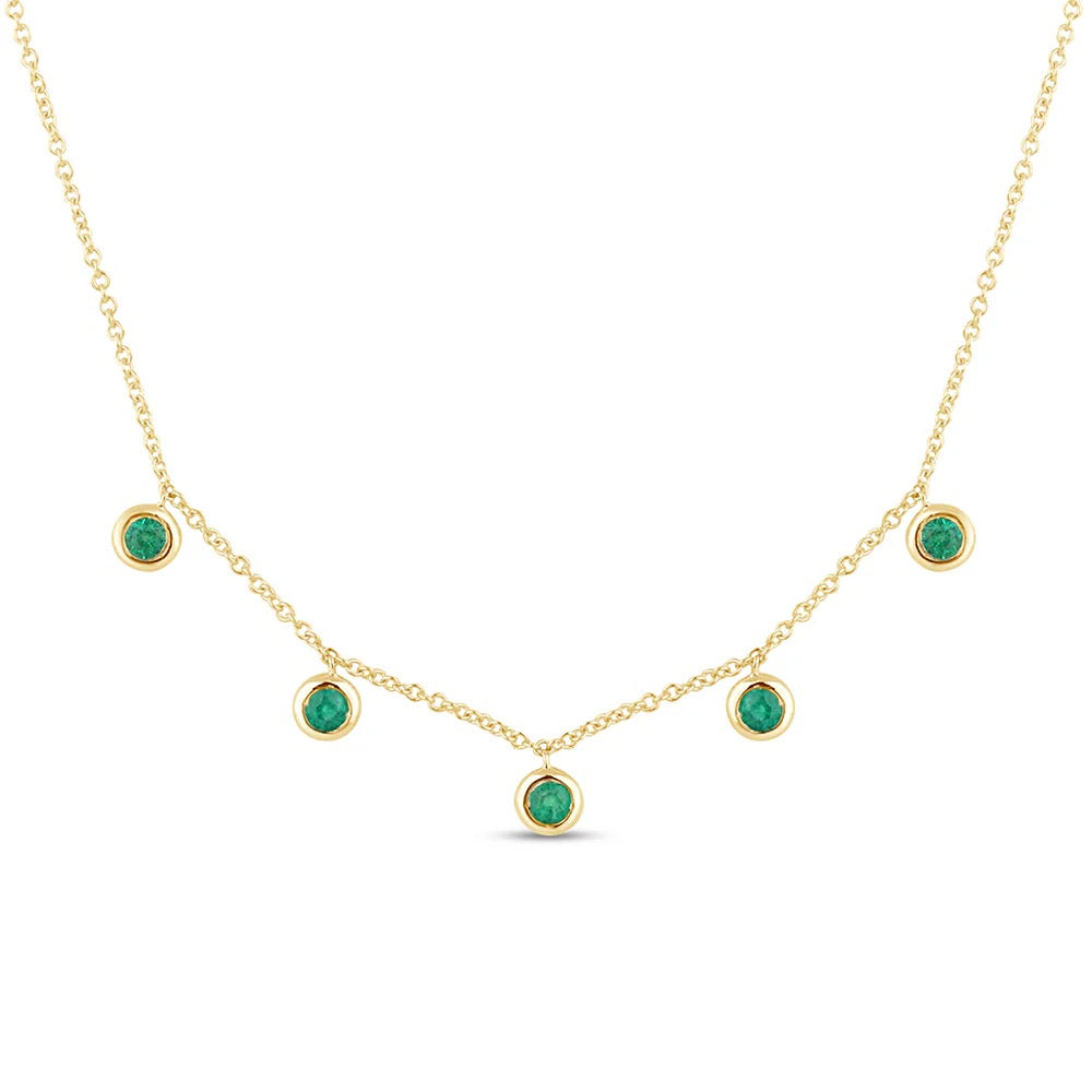 The Karat Concierge 14K yellow gold necklace featuring five bezel-set green emeralds on a delicate chain.