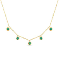 The Karat Concierge 14K yellow gold necklace featuring five bezel-set green emeralds on a delicate chain.