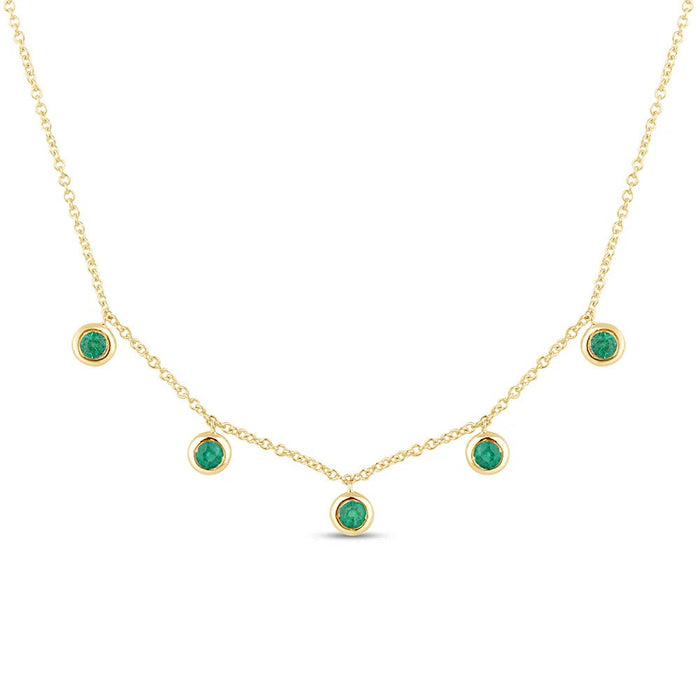 The Karat Concierge 14K yellow gold necklace featuring five bezel-set green emeralds on a delicate chain.