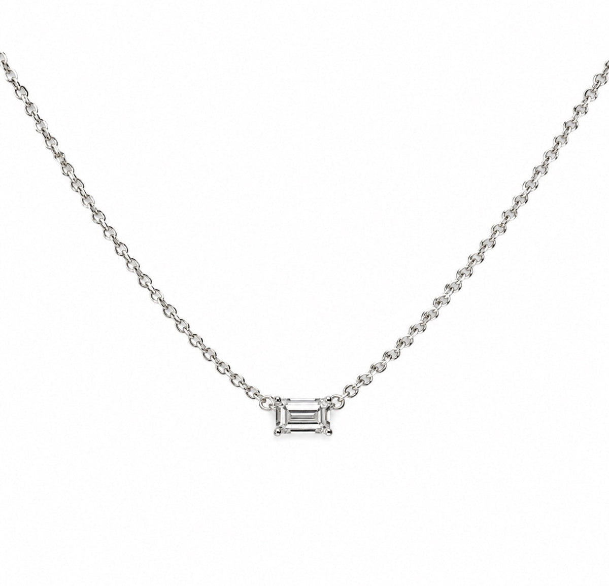 The Karat Concierge emerald cut solitaire diamond necklace on a delicate 14K yellow gold chain.