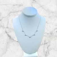 The Karat Concierge 14K white gold necklace with five bezel-set emerald-cut lab-grown diamonds on a display bust.