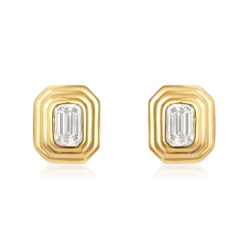 The Karat Concierge Gatsby emerald cut diamond stud earrings in 14K yellow gold with a faceted bezel setting.