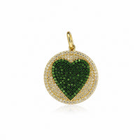 The Karat Concierge round pendant featuring a pavé emerald heart surrounded by diamonds in 14K yellow gold.
