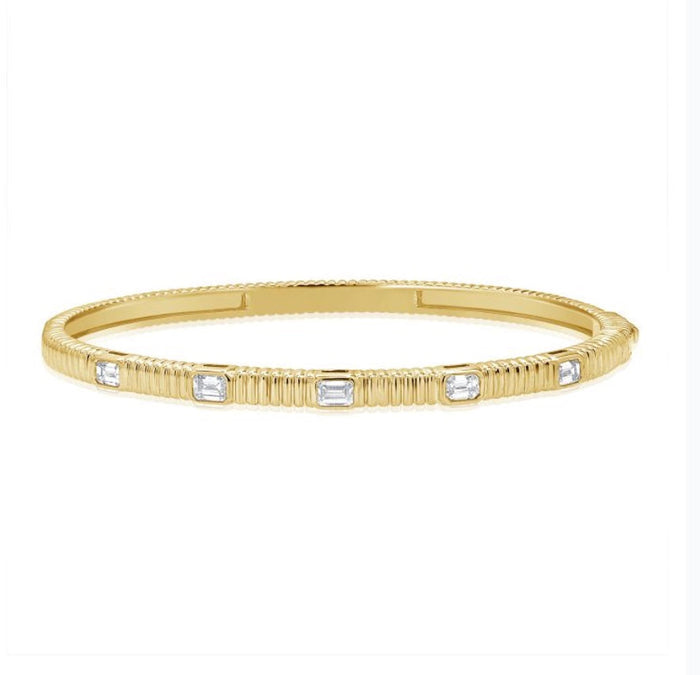 The Karat Concierge fluted gold bangle featuring five bezel-set emerald cut diamonds with a secure double latch.