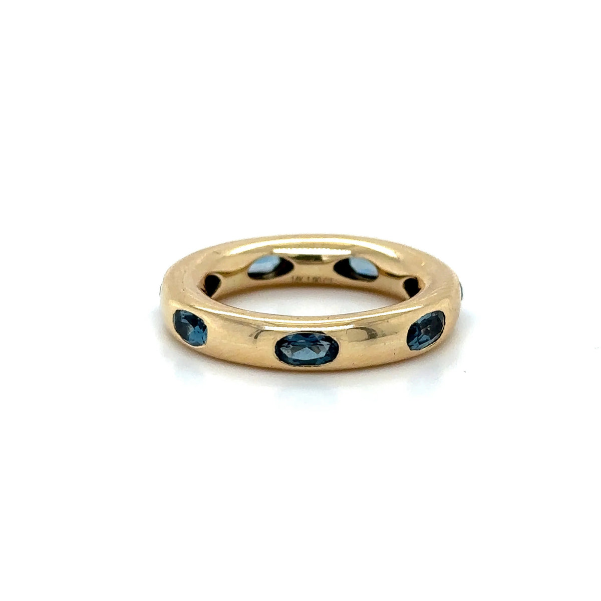 The Karat Concierge 14KT yellow gold donut ring featuring oval-shaped London Blue Topaz gemstones in a sleek setting.