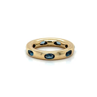 The Karat Concierge 14KT yellow gold donut ring featuring oval-shaped London Blue Topaz gemstones in a sleek setting.