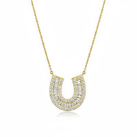 The Karat Concierge 14K yellow gold horseshoe necklace featuring baguette and round pavé diamonds on a delicate chain.
