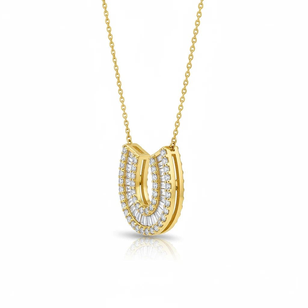 The Karat Concierge 14K yellow gold horseshoe necklace featuring pavé baguette and round diamonds on a delicate chain.