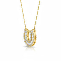 The Karat Concierge 14K yellow gold horseshoe necklace featuring pavé baguette and round diamonds on a delicate chain.