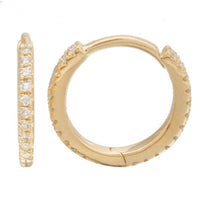 The Karat Concierge 14K yellow gold eternity huggie earrings featuring a row of sparkling diamonds.