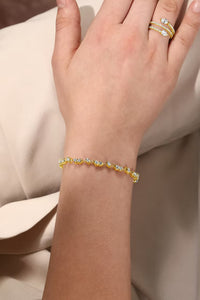 The Karat Concierge tennis bracelet in 14K yellow gold with alternating diamond shapes worn on a wrist.