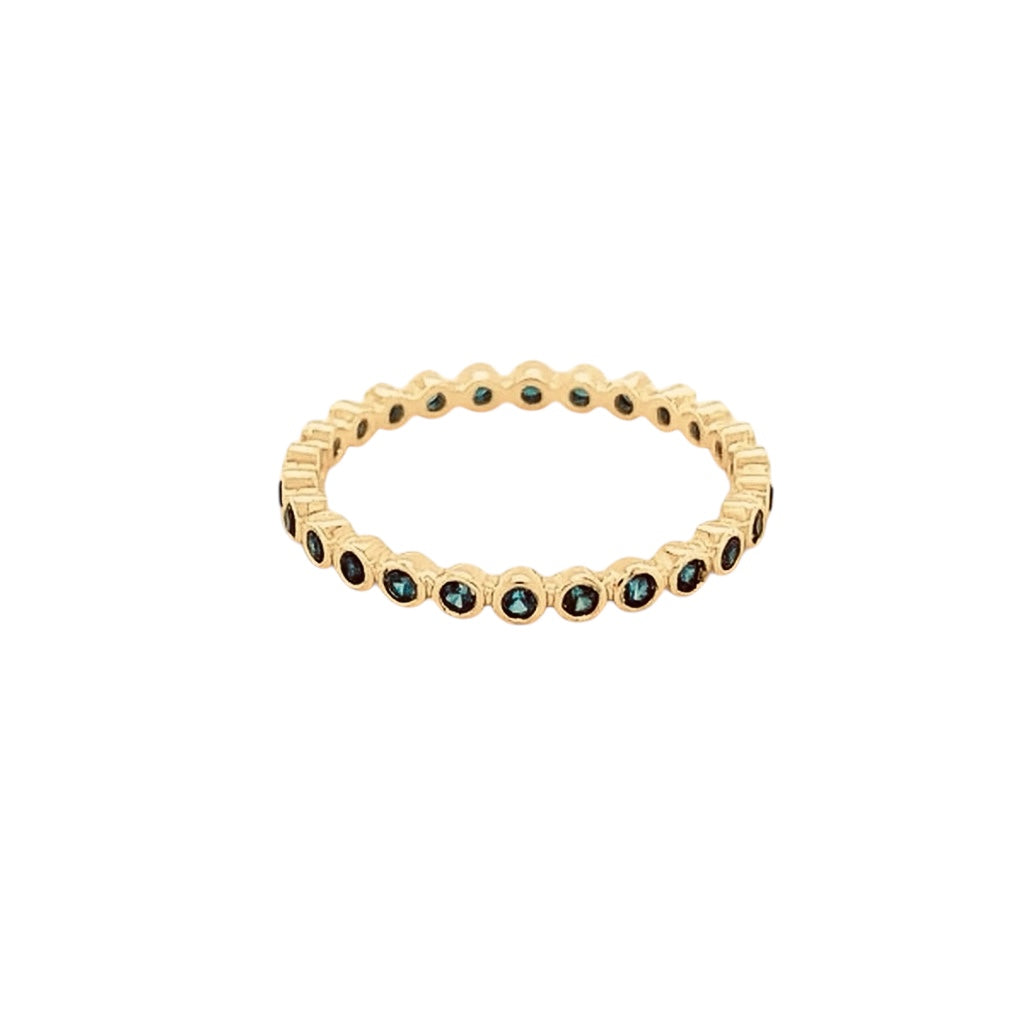 The Karat Concierge 14K yellow gold eternity band featuring a continuous row of bezel-set dark blue sapphires.