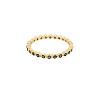 The Karat Concierge 14K yellow gold eternity band featuring a continuous row of bezel-set dark blue sapphires.