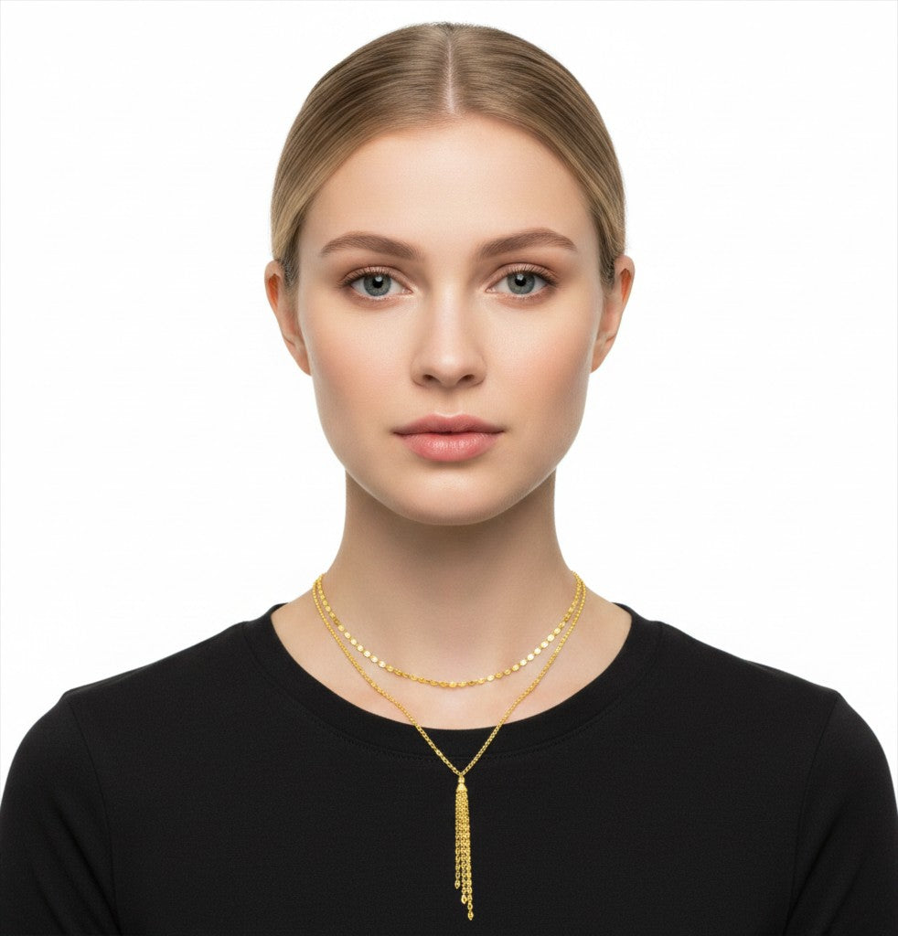 The Karat Concierge gold Valentino lariat necklace with a sliding bolo and delicate chain fringe on a model.