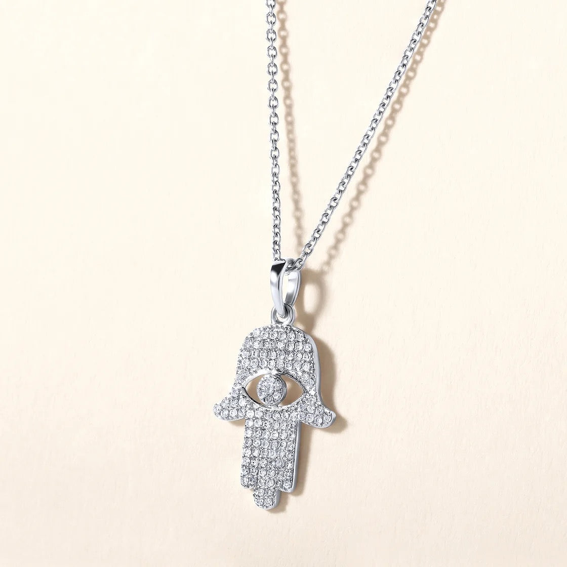 The Karat Concierge 14K gold Hamsa pendant necklace encrusted with 109 sparkling natural diamonds on a silver chain.
