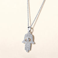 The Karat Concierge 14K gold Hamsa pendant necklace encrusted with 109 sparkling natural diamonds on a silver chain.