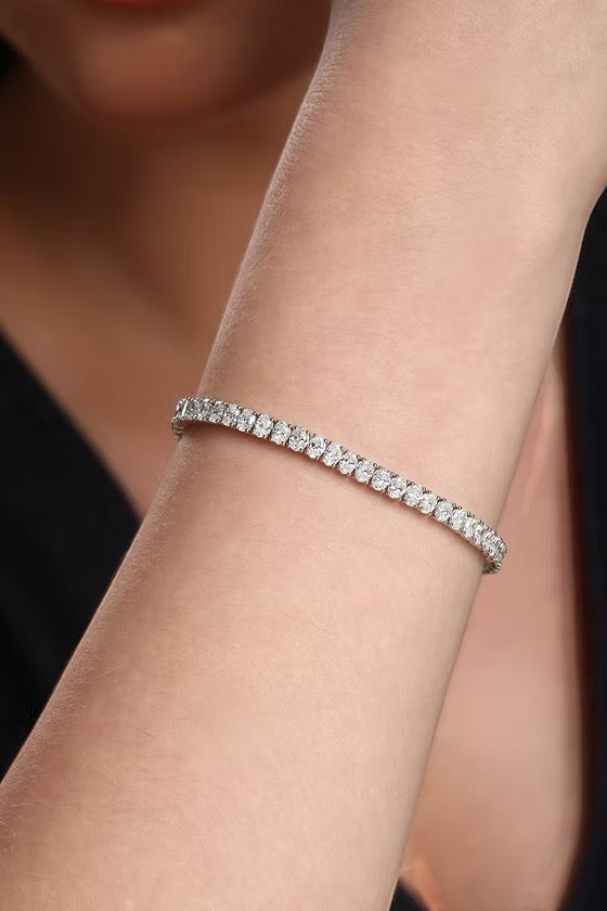 The Karat Concierge 8.6 carat oval diamond tennis bracelet in 14K white gold worn on a woman's wrist