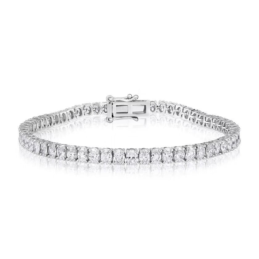 The Karat Concierge 14K white gold tennis bracelet featuring oval-cut diamonds set north to south with safety latches.