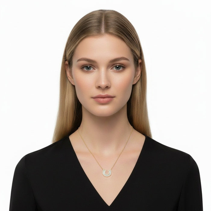 The Karat Concierge Fortuna Pave Horseshoe Necklace in 14K yellow gold with baguette and round pavé diamonds.