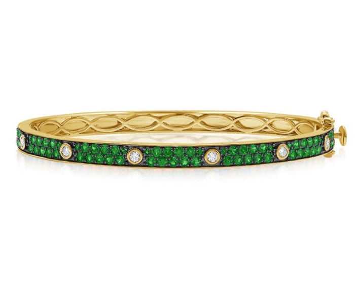 The Karat Concierge Pave Muse bangle in yellow gold featuring green pavé gemstones and bezel-set diamond accents.