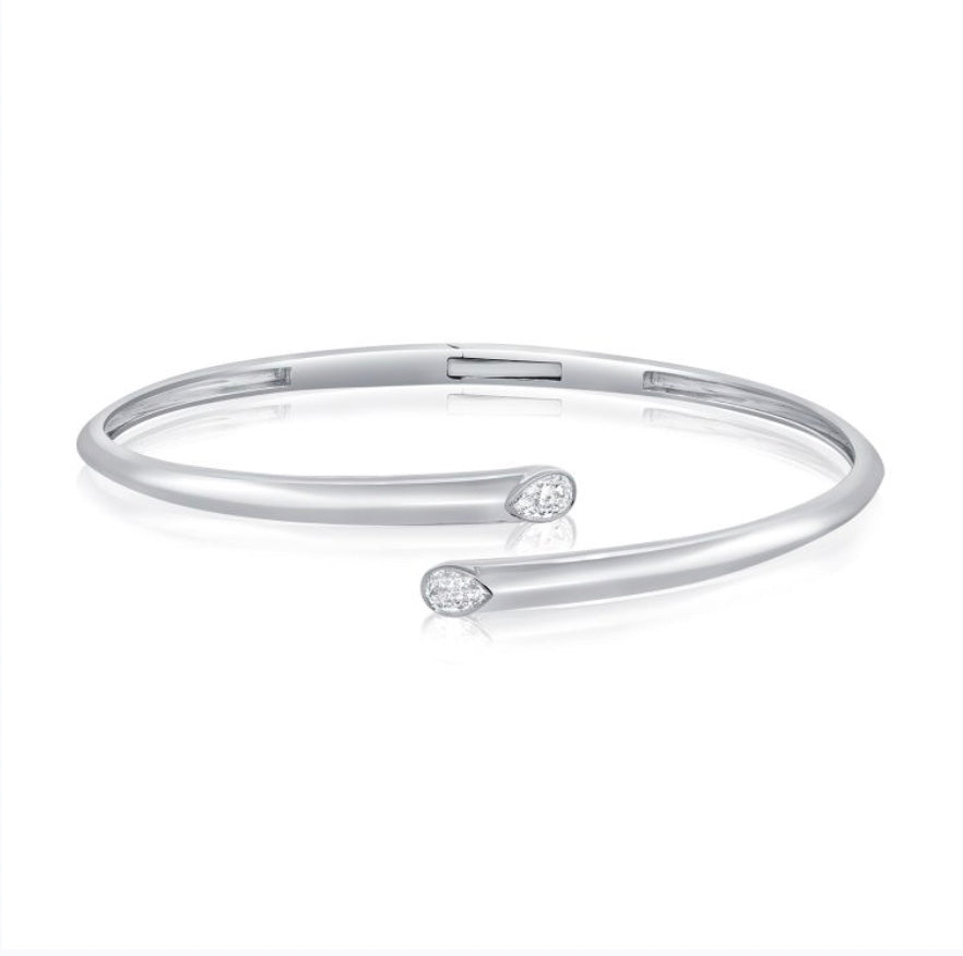 The Karat Concierge hinged cuff bangle in white gold featuring two pear-shaped bezel set diamonds.