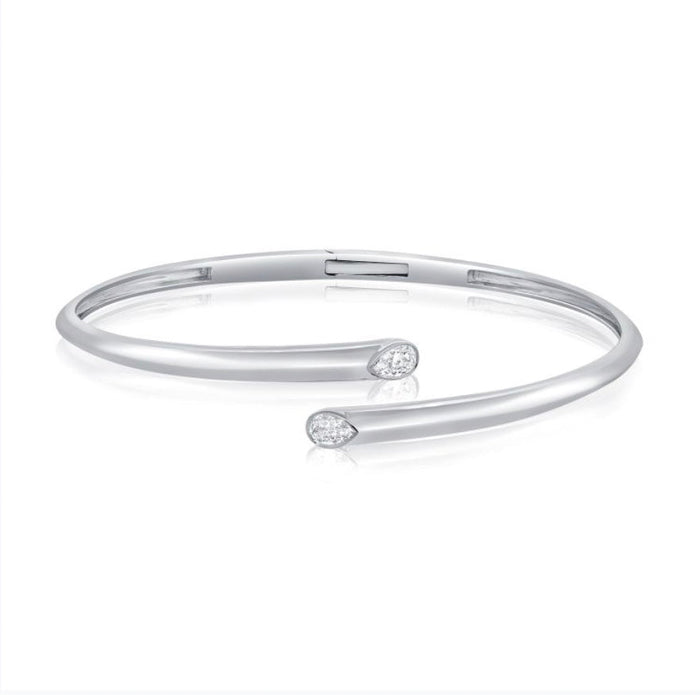 The Karat Concierge hinged cuff bangle in white gold featuring two pear-shaped bezel set diamonds.