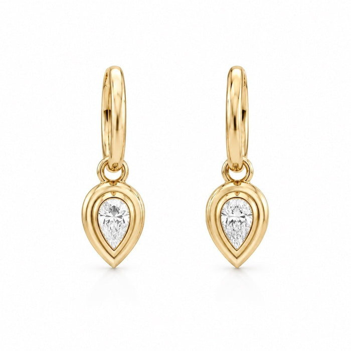 The Karat Concierge Gatsby Pear Huggies in 14K yellow gold with pear-shaped natural diamond bezels.