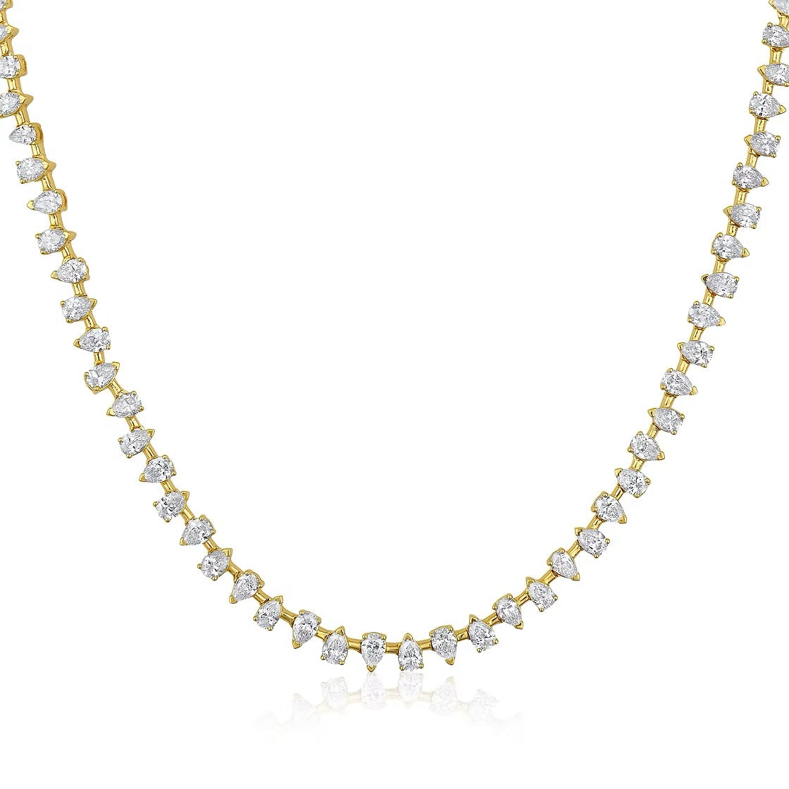 The Karat Concierge Meridian tennis necklace featuring pear-shaped diamonds set in 14K yellow gold.