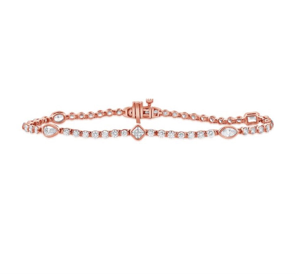 The Karat Concierge Kate bezel set tennis bracelet in rose gold with mixed shape diamonds and round diamond accents.