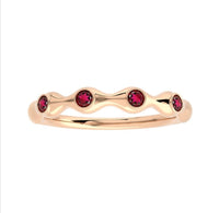 The Karat Concierge 18K gold bamboo-style ring featuring four round ruby gemstones in a delicate stackable design.