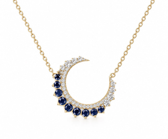 The Karat Concierge 14KT yellow gold crescent moon necklace with brilliant diamonds and rich blue sapphires.